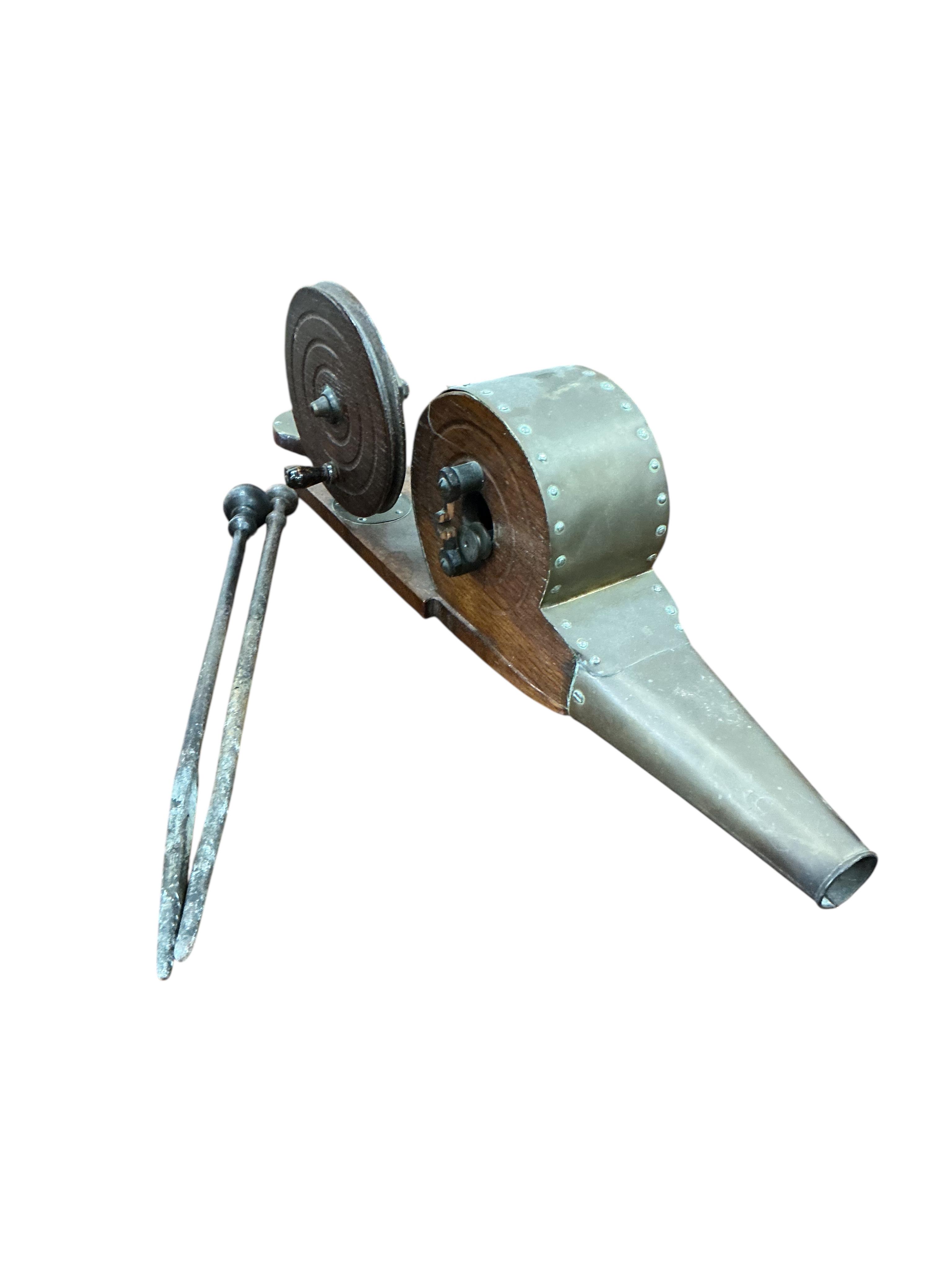 A Victorian brass mounted oak fire bellows, a circular copper log bin and assorted implements